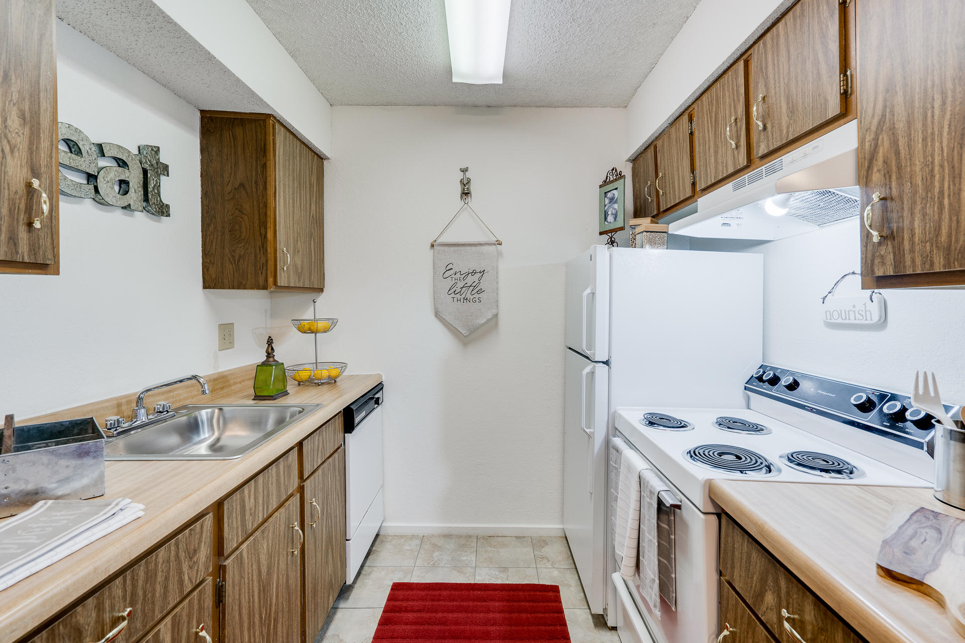 Kitchen With White Appliances & Tile-Style Flooring