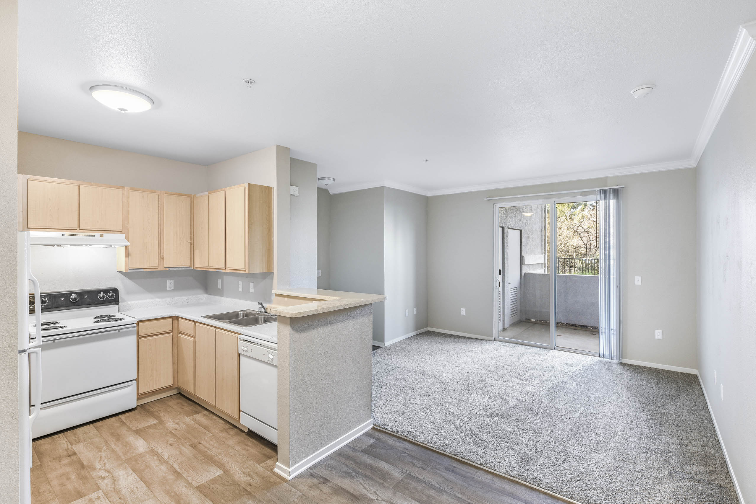 Open kitchen and living space with balcony