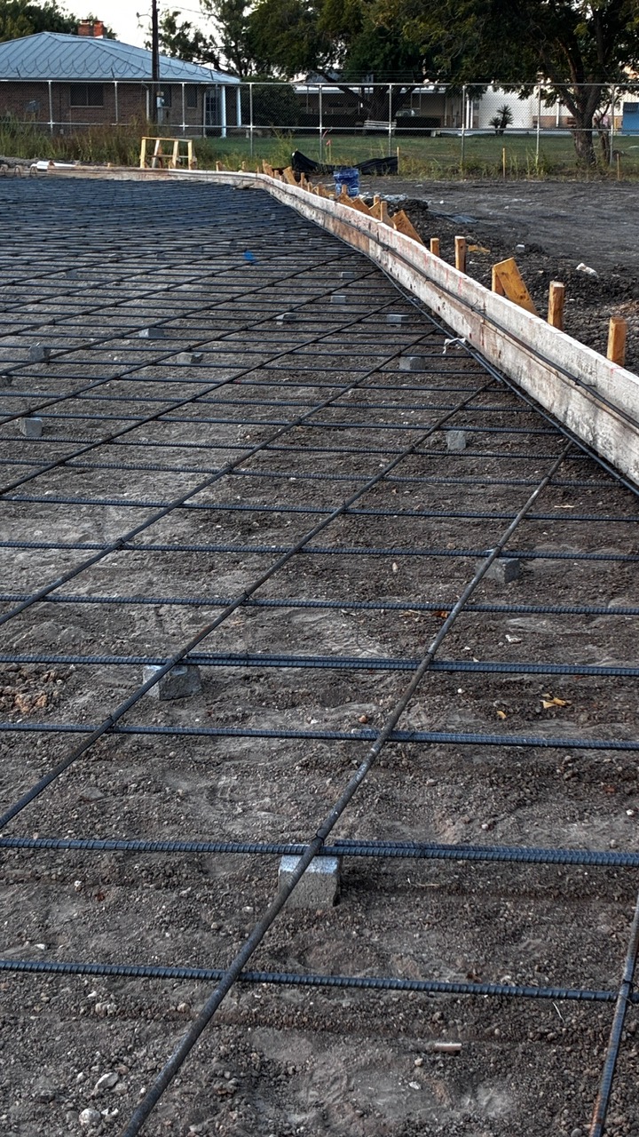 Commercial construction foundation preparation featuring reinforced steel rebar installation prior t 