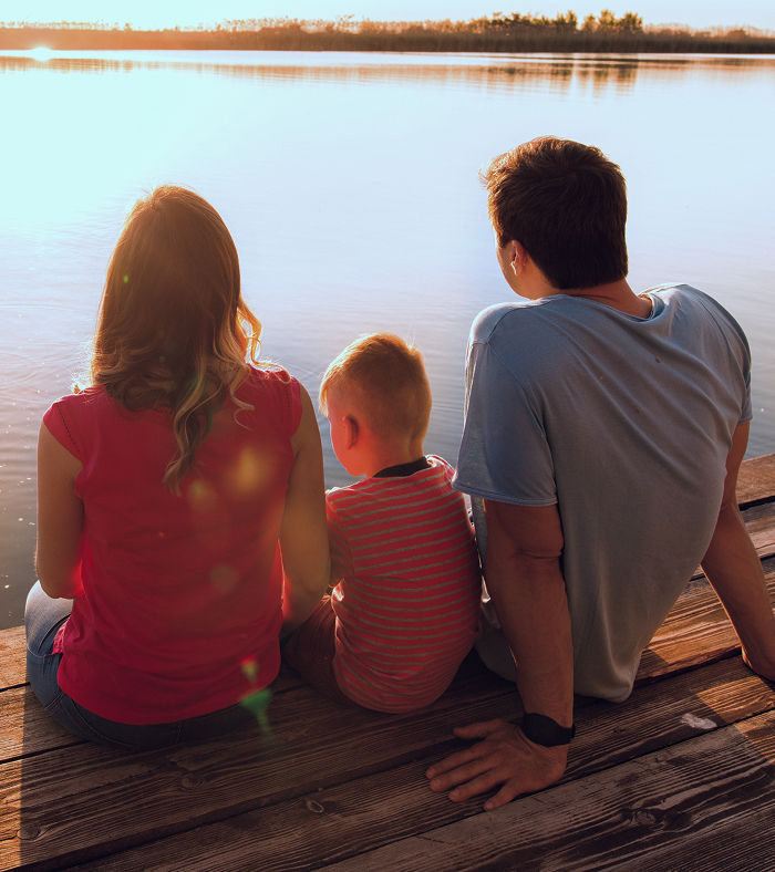 A family on a dock enjoying the view.