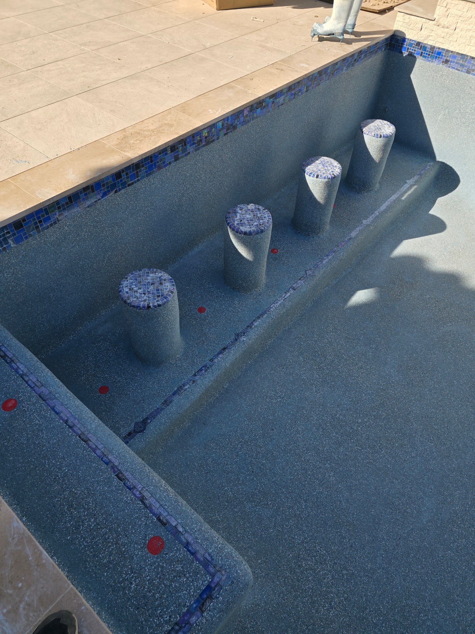 Custom in-pool stools add another way to enjoy a swimming pool while creating a distinctive architec 