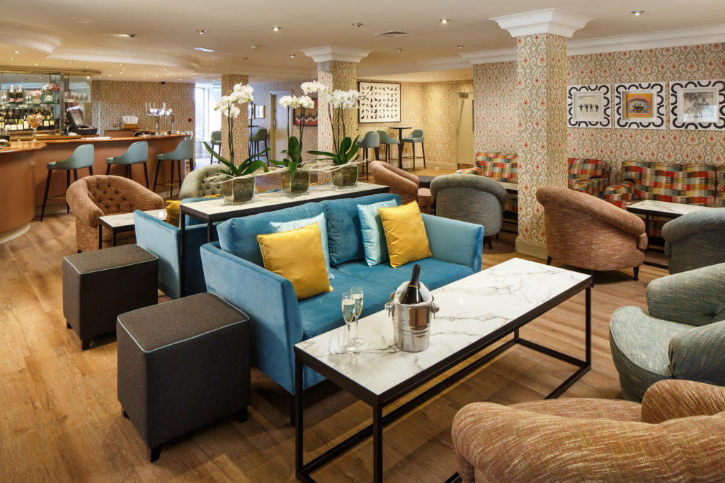 Bar and lounge area at Mercure Maidstone Great Danes hotel with bottle of fizz and two glasses on ta Mercure Maidstone Great Danes Hotel Maidstone 01622 528565