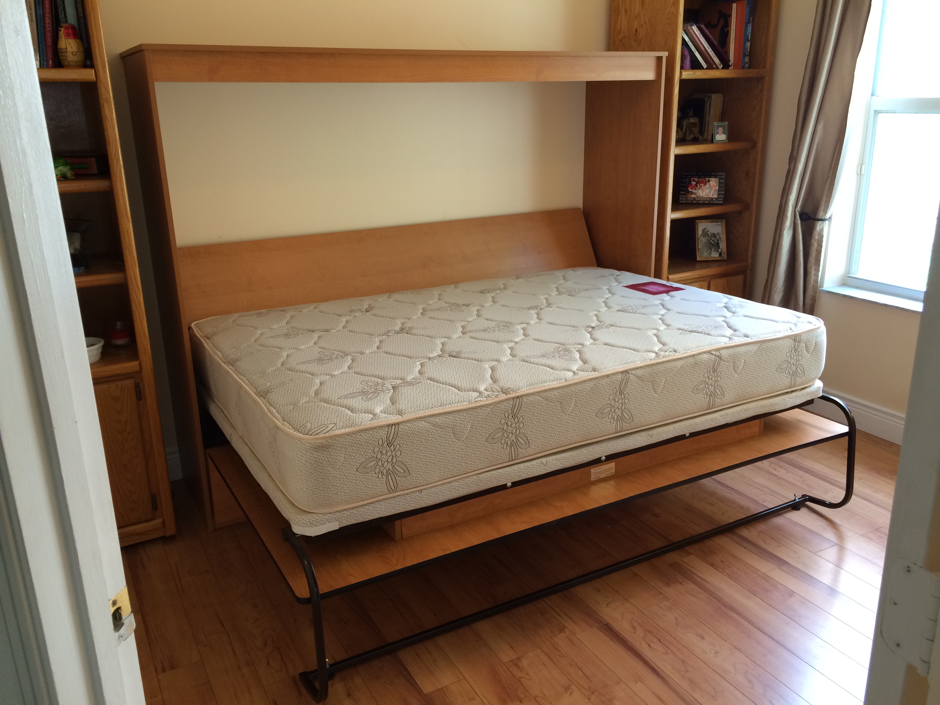 Maple wood horizontal Murphy bed open with built in shelving