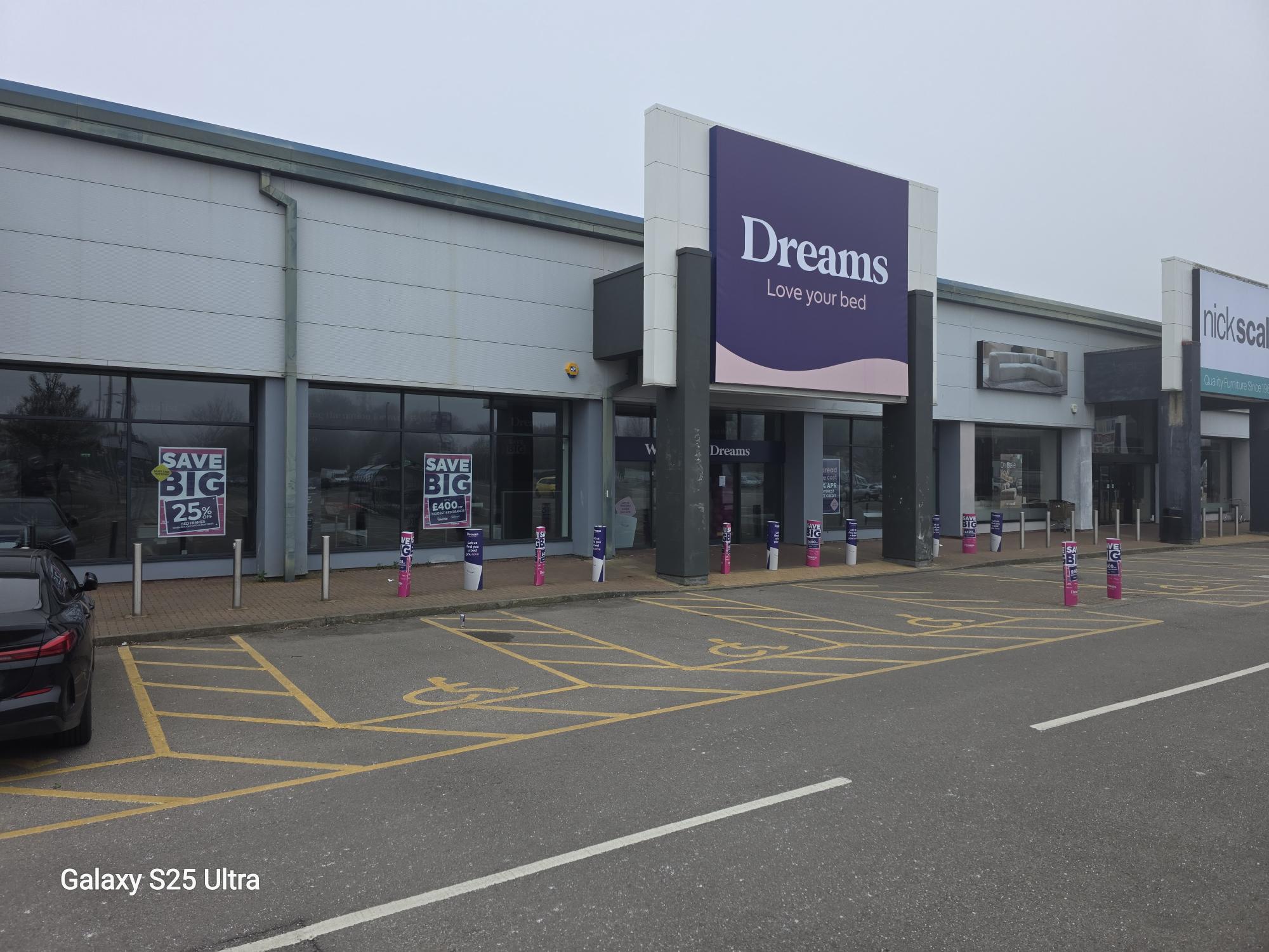 Dreams store front, showing disabled parking and accessible entry.