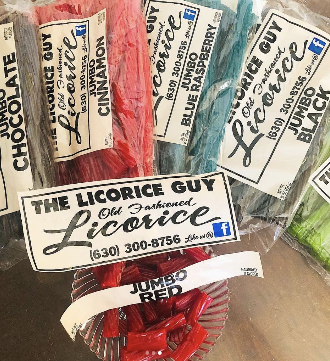 A spread of The Licorice Guy's full product lineup, including Jumbo Chocolate, Cinnamon, Blue Raspberry, Black, and Red flavors. Each bag features the brand's old fashioned licorice label with contact information and social media icons.