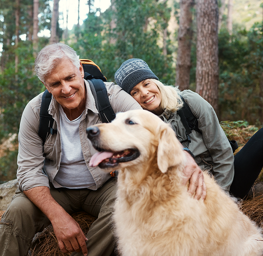 Couple on a hike with their Golden Retriever.