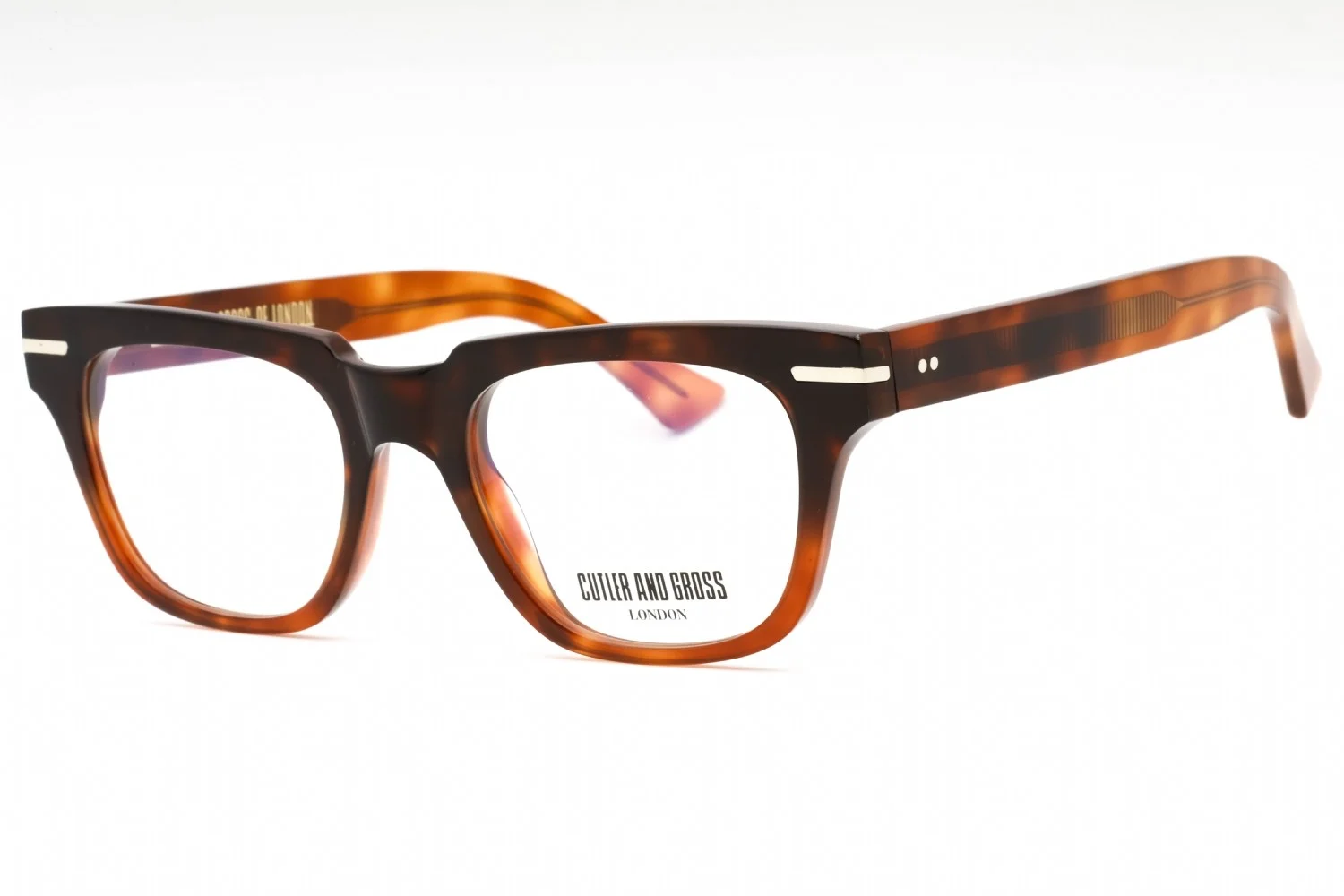 A pair of tortoiseshell eyeglasses from Cutler and Gross London are displayed against a white background. The glasses have a thick, angular frame with a gradient from dark brown to amber and distinctive metal accents on the temples. The brand name and location are printed in white on the lower inside rim of the right lens.