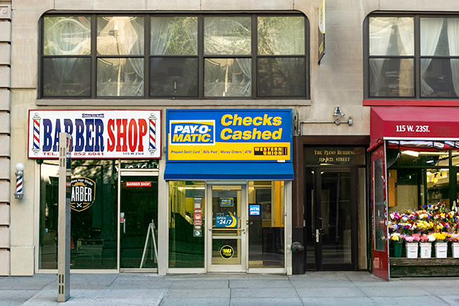 Exterior view from street of PAYOMATIC store located at 115 West 23rd St New York, NY 10011