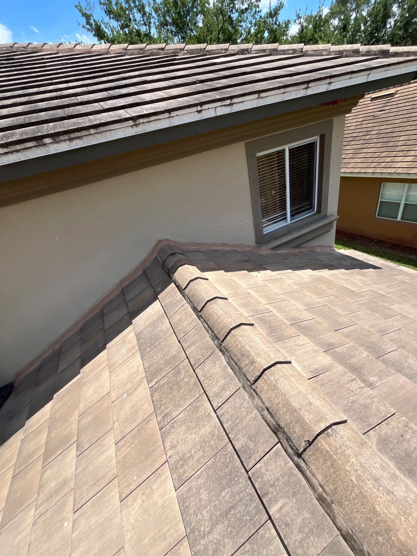 Clean view of a finished tile roof on a Florida home, showing quality workmanship and a durable resi 