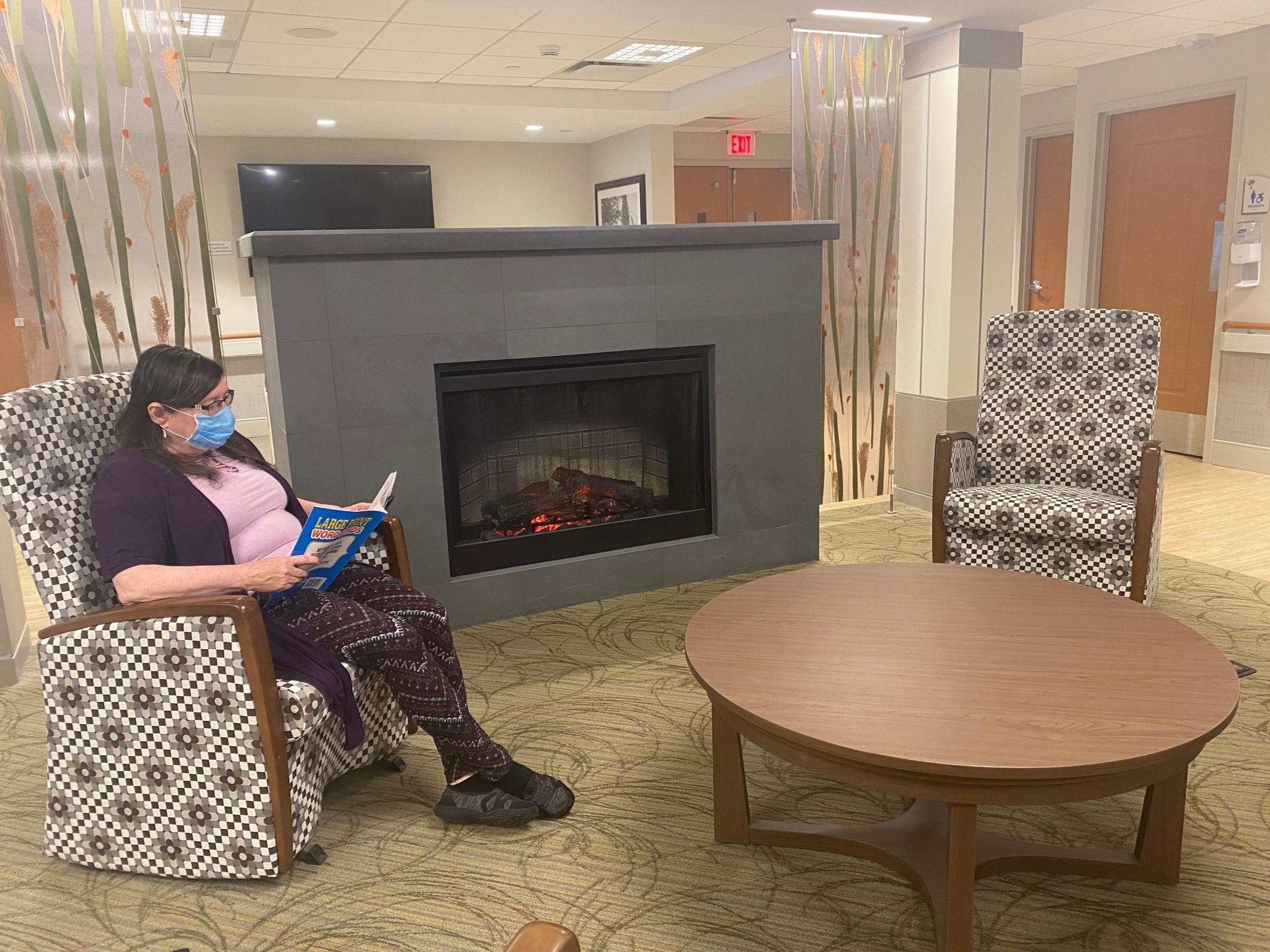 Shaker Place Rehabilitation and Nursing Center Resident reading in common area