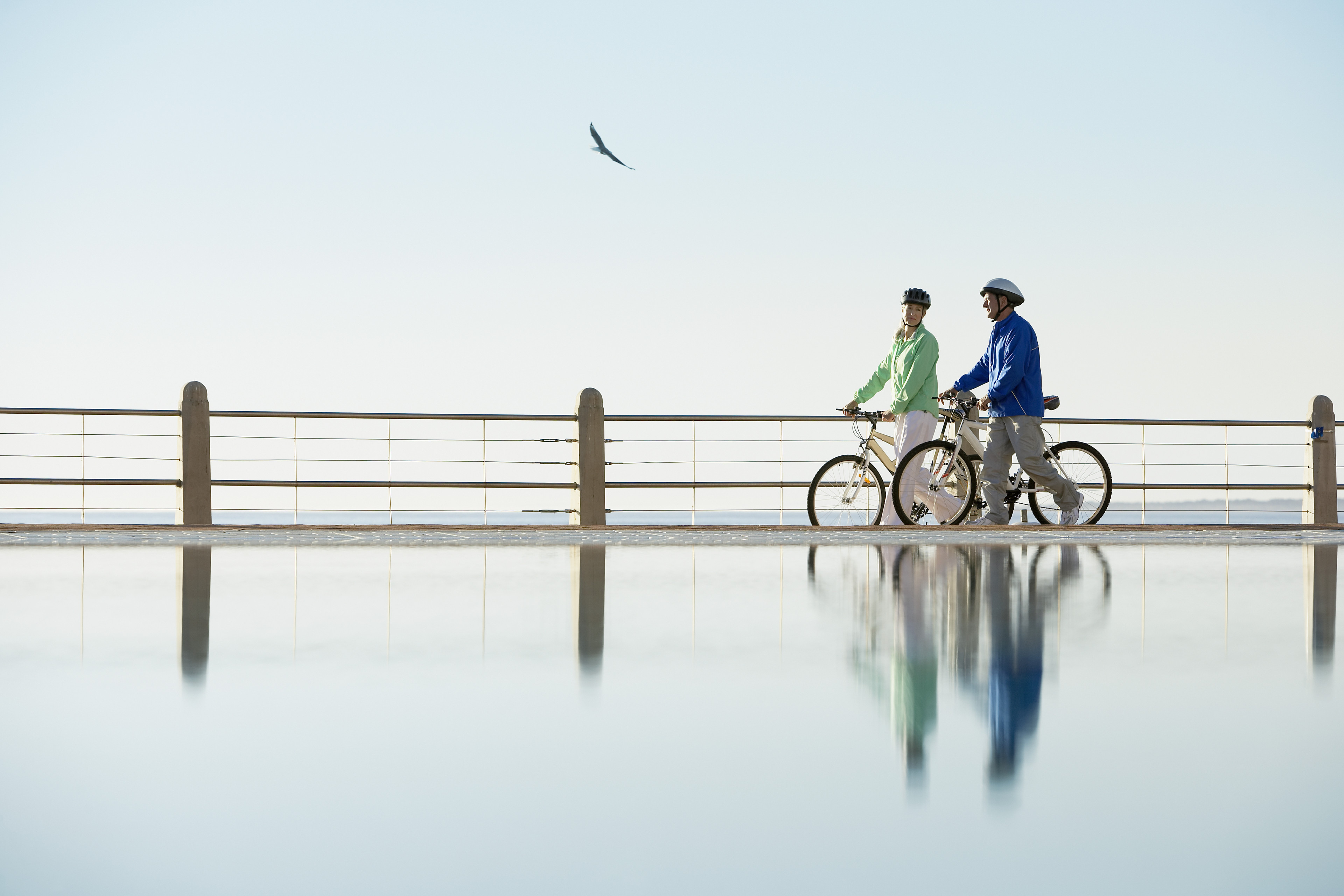 Couple walking bikes by the water.jpg