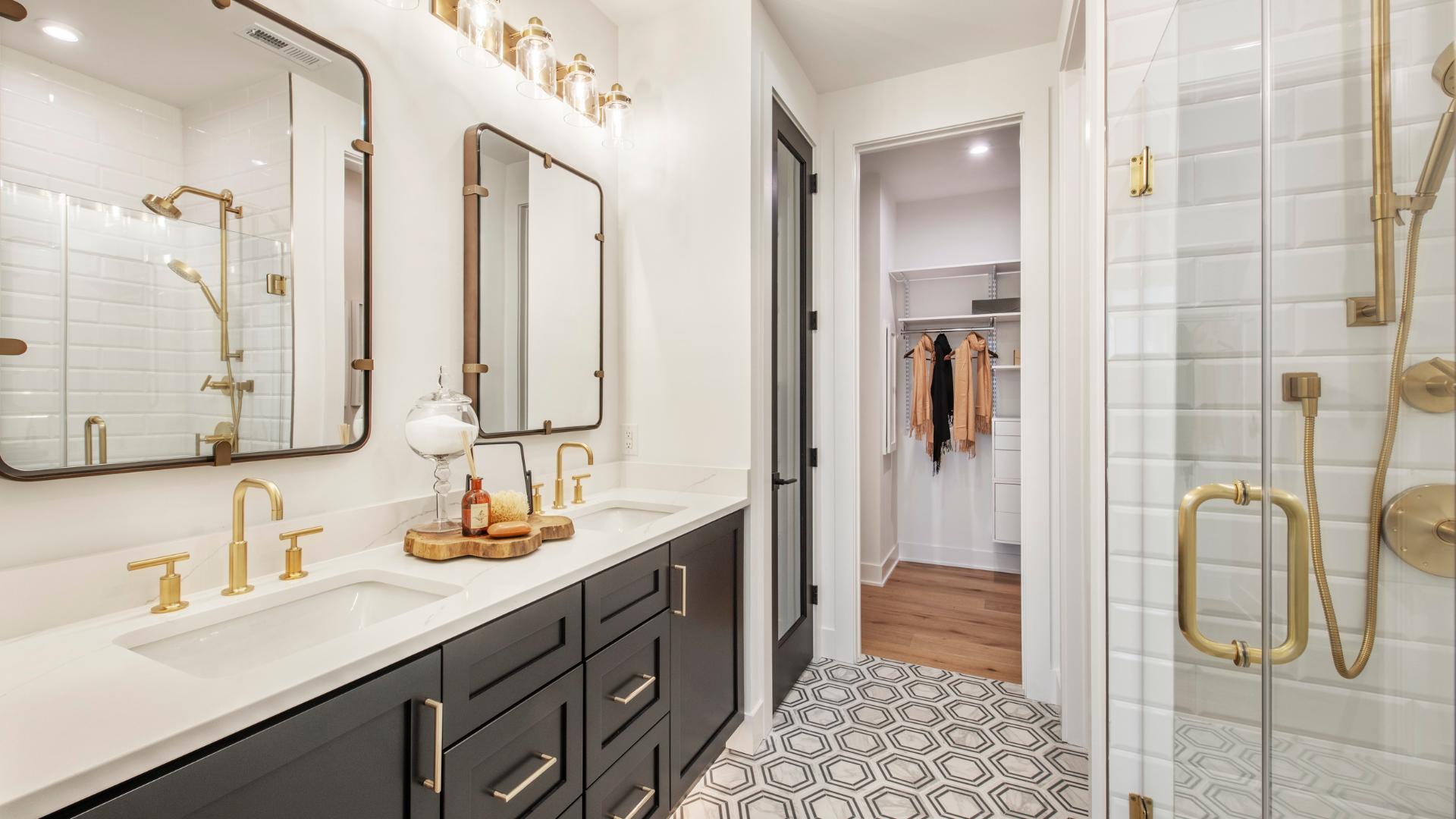 Spa-like primary bath with dual-sink vanity and luxe shower