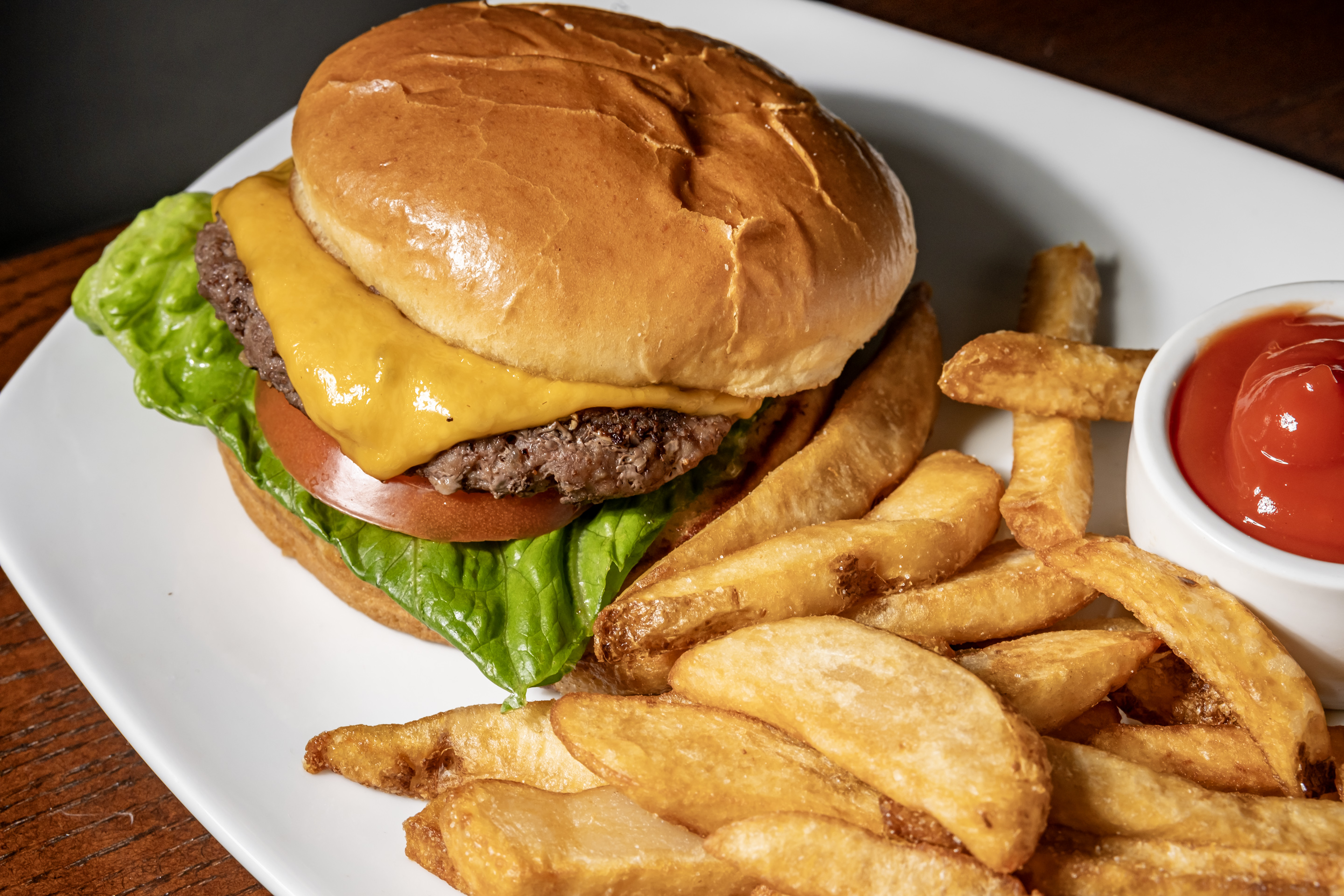 Juicy, flame-grilled beef patty topped with melted cheese, fresh lettuce, tomato, and house sauce, served on a toasted bun.