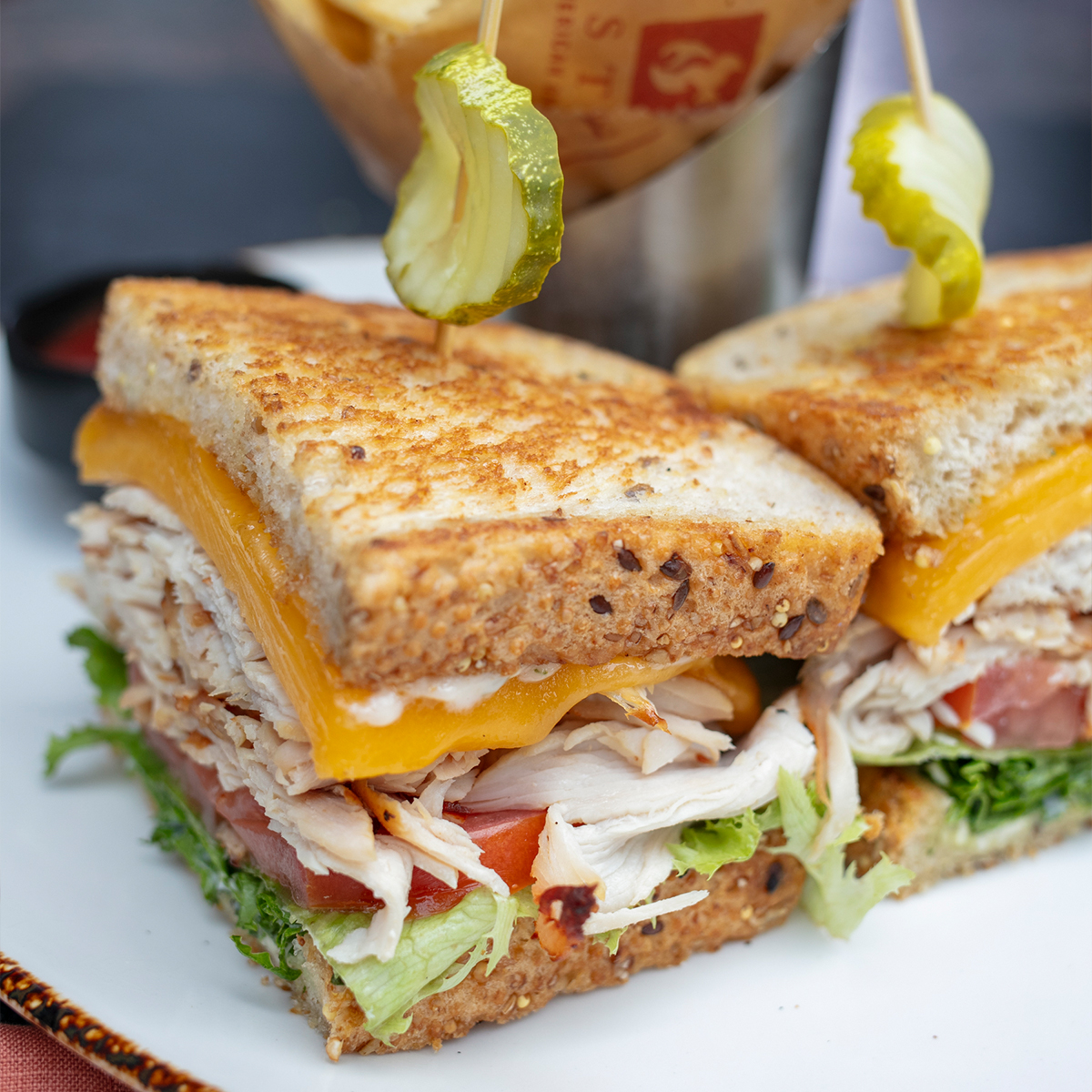 Rotisserie Turkey Sandwich | sliced turkey breast, basil mayo, sliced cheddar, lettuce, tomato