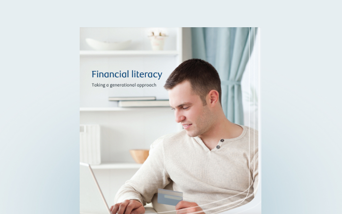 Cover of the financial literacy guide with a young man on his laptop.