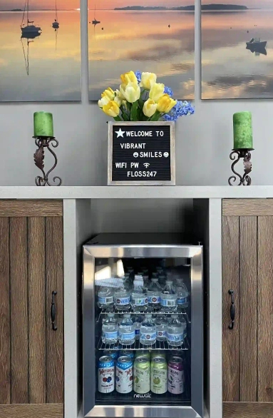 Patient refreshment station with drinks and welcome amenities at Vibrant Smiles of Holland