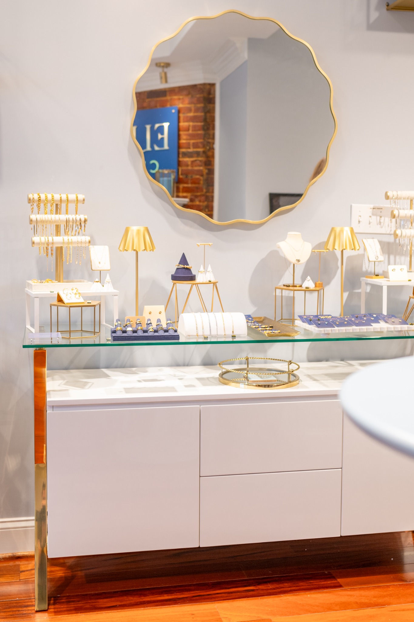 Browse Eliana Curated's elegant fine jewelry display featuring necklaces, bracelets, rings, and earrings in a modern boutique in Alexandria, VA.