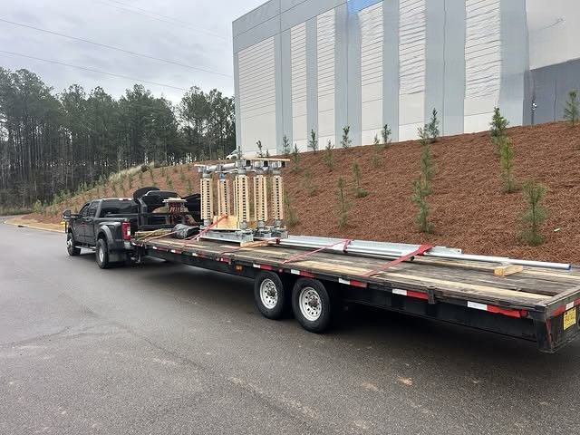 Electrical or industrial equipment is safely secured on a flatbed trailer, highlighting professional 