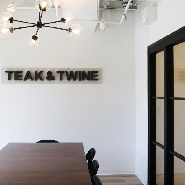 Teak & Twine sign in conference room.