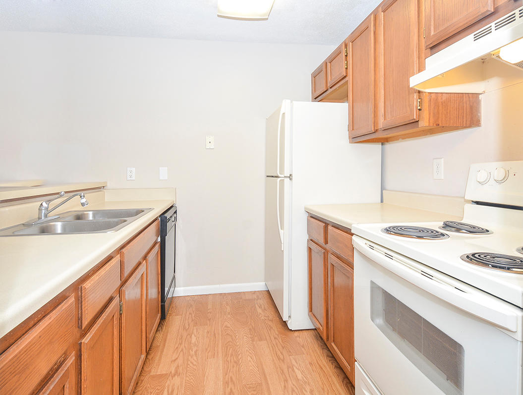 Fully-Equipped Kitchen With White & Black Appliances