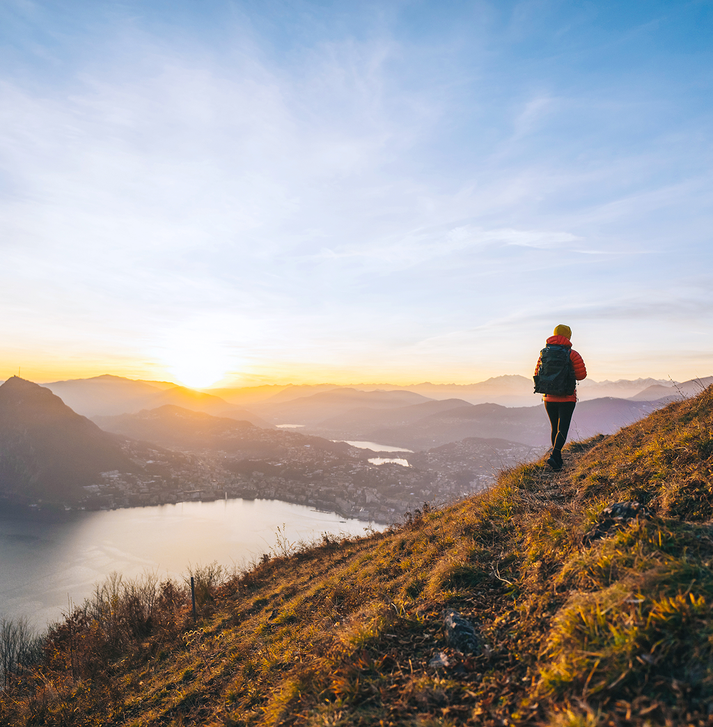 An individual on a scenic hike at sunrise.