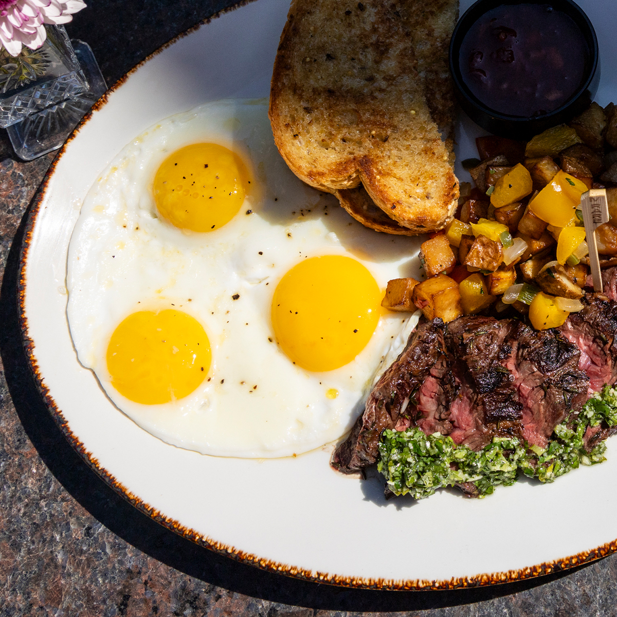 Steak & Eggs | bistro steak, cilantro chimichurri, 3 eggs to order, multigrain toast, strawberry marmalade, & breakfast potatoes