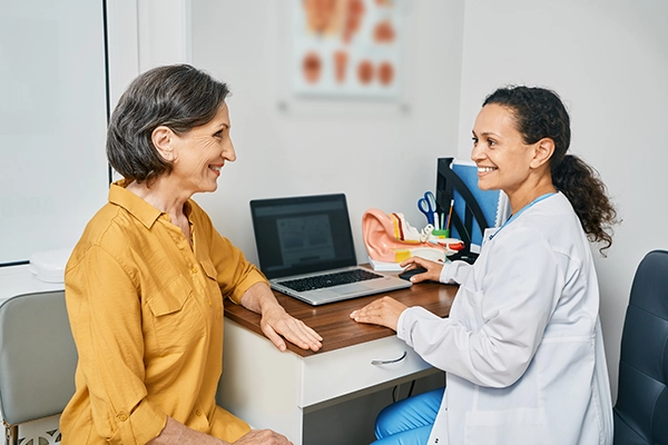 Mulher sendo atendida por fonoaudióloga