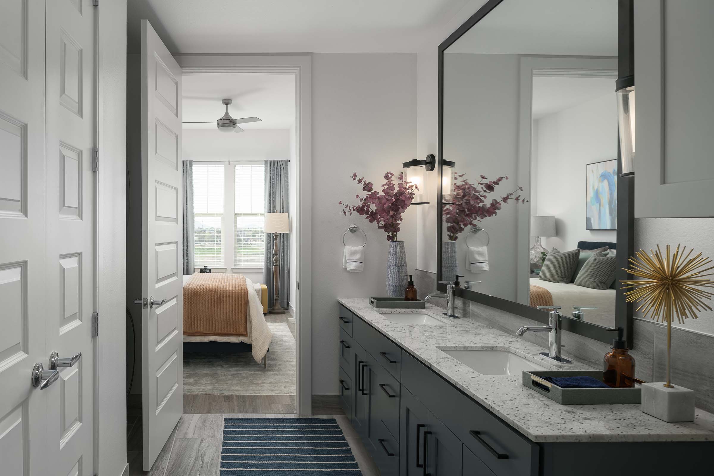 Bathroom ensuite with slate cabinets looking into bedroom at Camden Gilbert apartment homes in Gilbert, AZ