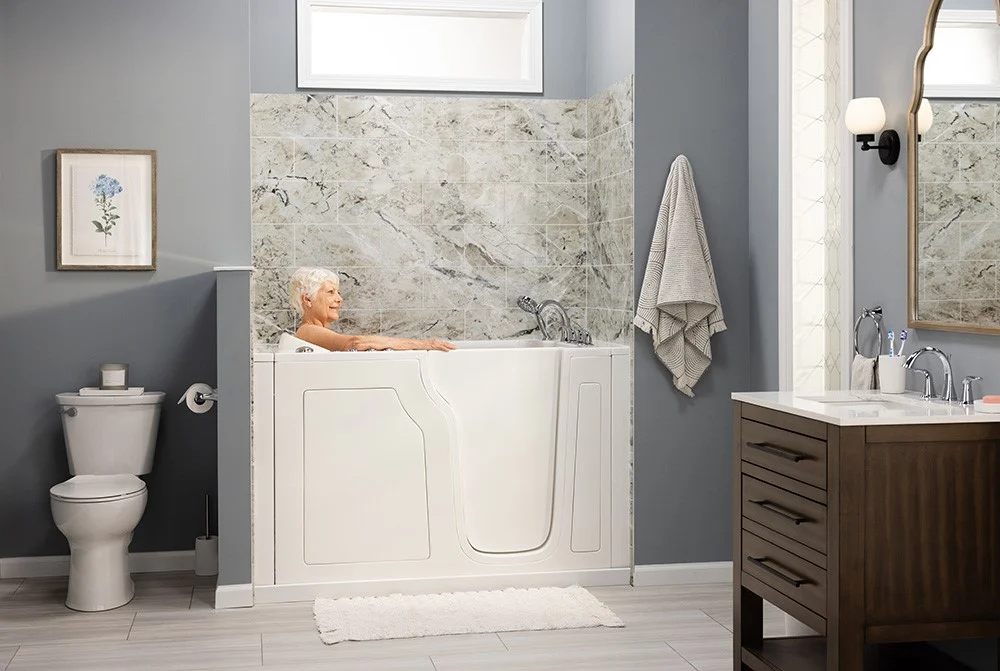 Walk-in bathtub installation by Luxury Bath featuring easy-access entry, built-in seating, and wall  