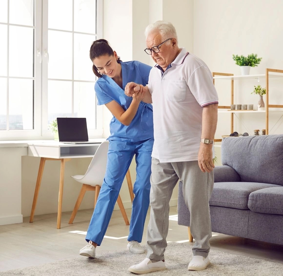 A CareMate Home Health Care professional helping a senior with balance and rehabilitation exercises in Saint Paul, Minnesota. Our experienced home health team delivers personalized care plans, post hospital recovery support, skilled nursing services, and in-home therapy assistance tailored to each client&rsquo;s needs.