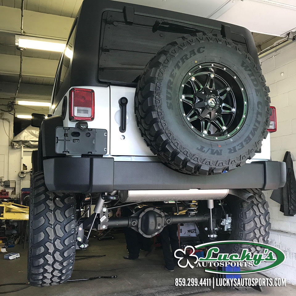 Lucky's Offroad performing a suspension lift on a Jeep Wrangler.