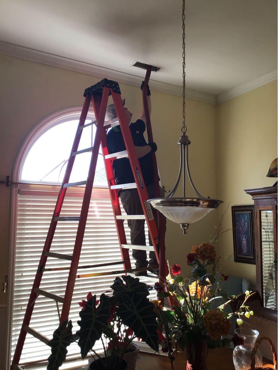 Removing soot from ceiling after fire to customers home.