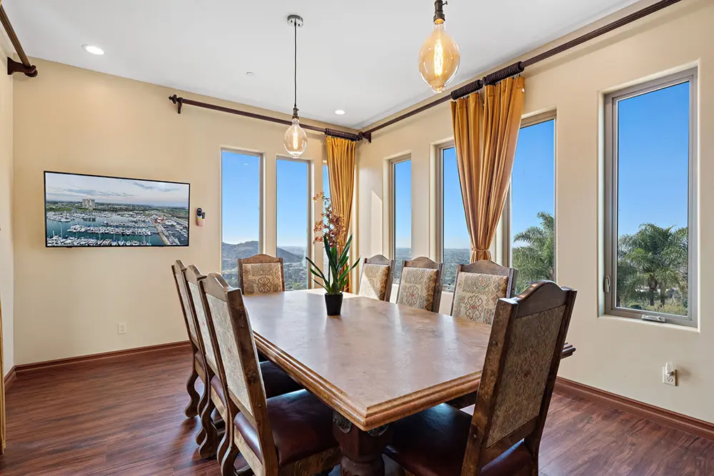 Solid wood dining table with beautiful nature views, offering a serene setting that encourages connection and mindful meals during recovery.