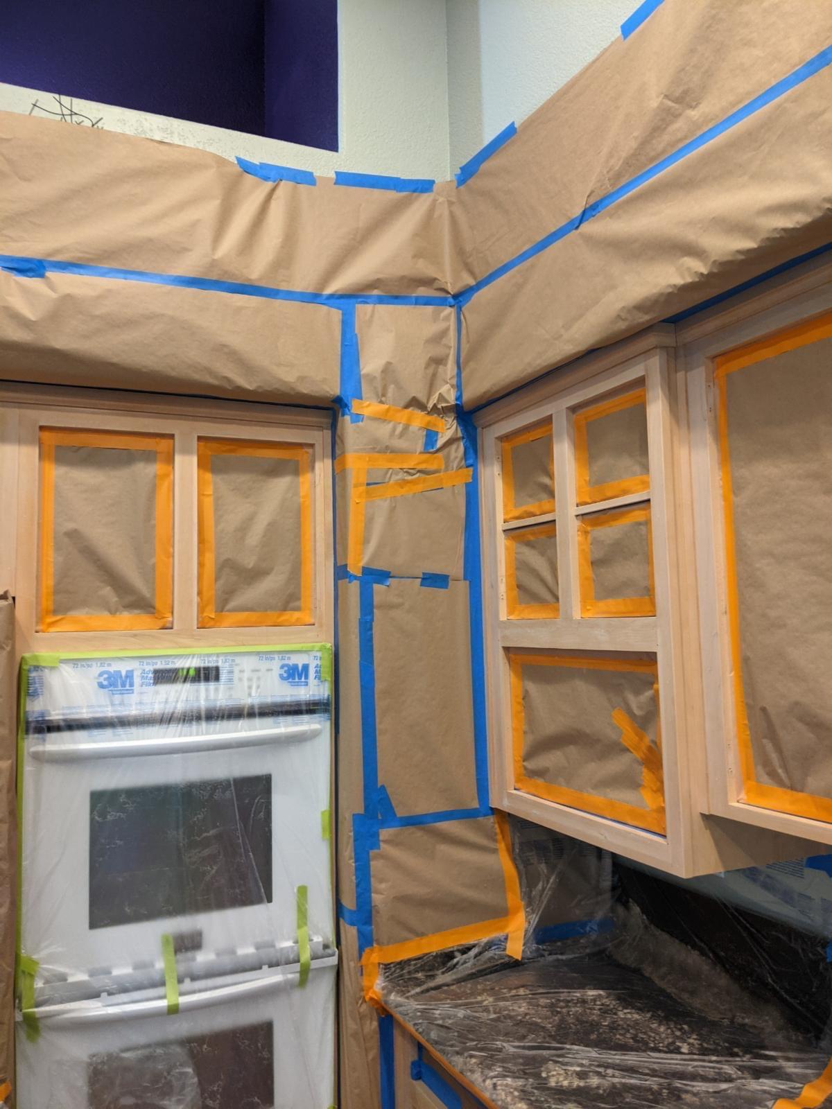 extensive masking of your kitchen cabinets is important, plus you don't have to remove all your stuff
