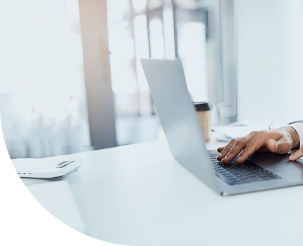 A close-up shot of a person at their laptop.