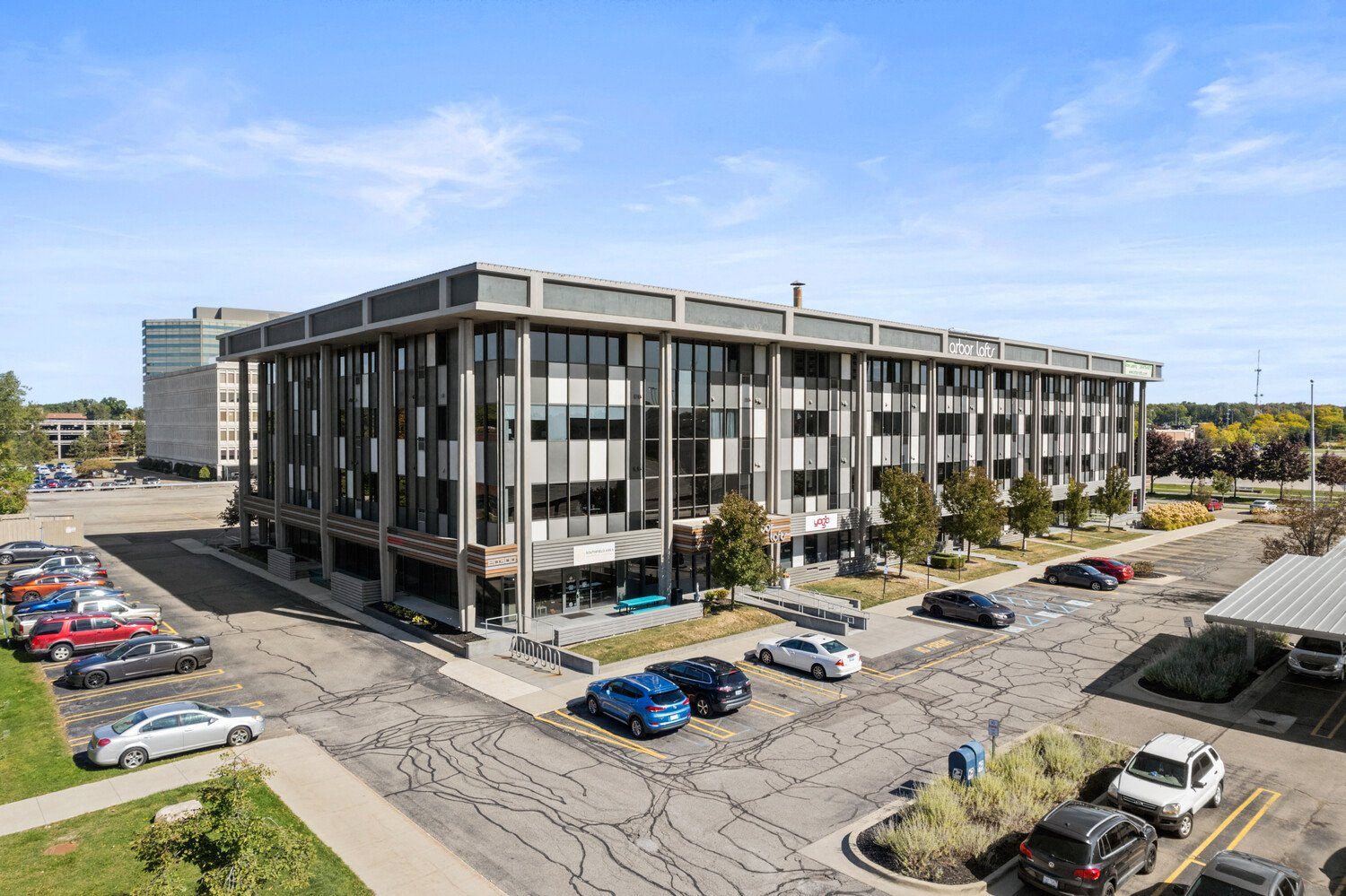 an aerial view of an office building with cars parked in a parking lot