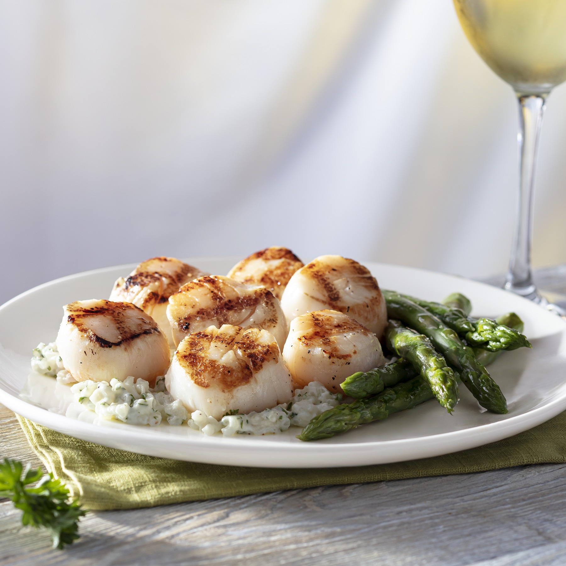 Caramelized Grilled Sea Scallops served with asparagus and mascarpone risotto.