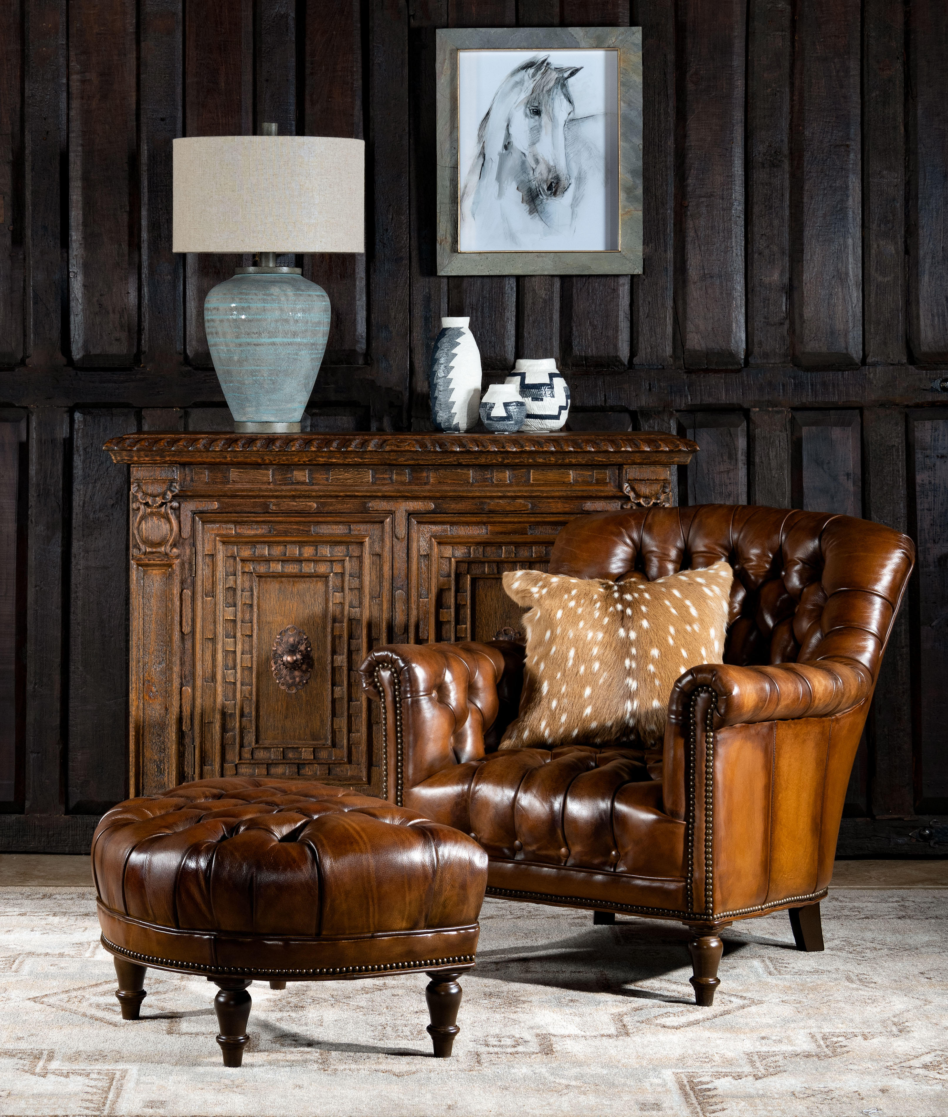 Inspired by the vintage armchairs you'll find in Victorian homes, designs like this Chesterfield-inspired leather chair fit just as well into wood-paneled libraries as they do in downtown studio apartments. Designed by artisan skilled craftsmen with a rounded back, low arms, and true brass nailhead trim, it's upholstered in top grain leather and features deep diamond tufted button accents along the inner back, arms, and seat. Our perfectly antiqued leather provides a true vintage look giving our Winchester Tufted Leather Lounge Chair a timeless appeal! 100% American Made to the highest standards of quality and craftsmanship!