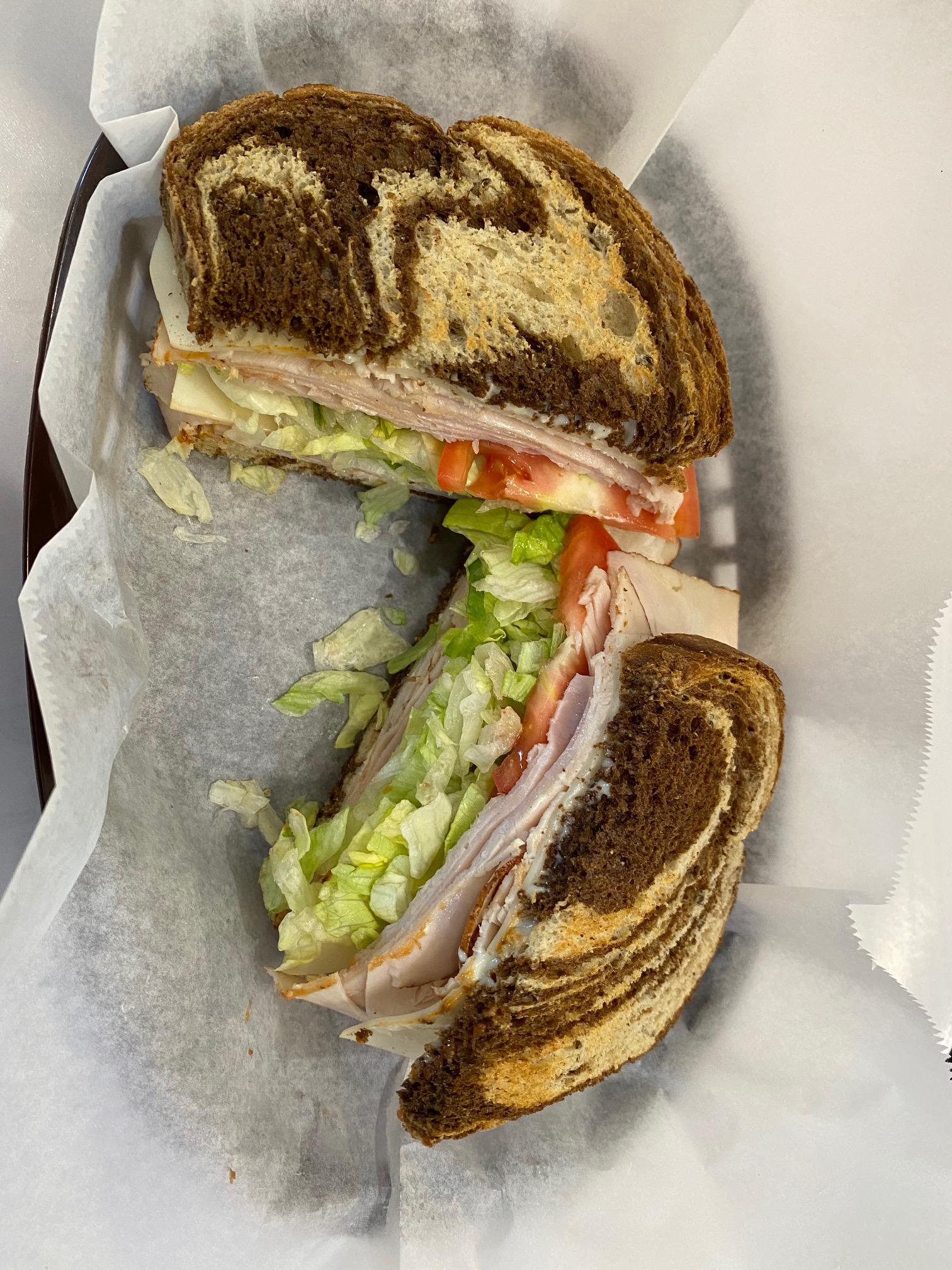 Deli sandwich - Turkey on Rye with provolone, lettuce and tomato