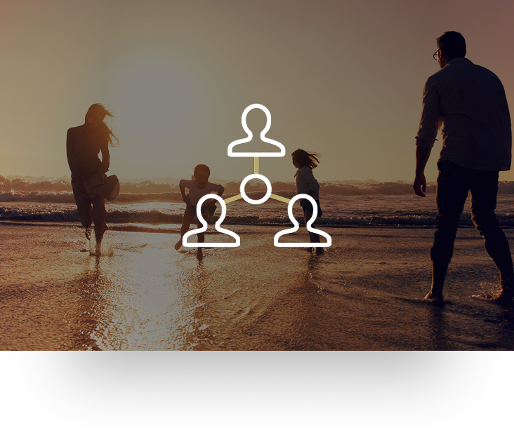 Family of four playing on the beach at sunset.