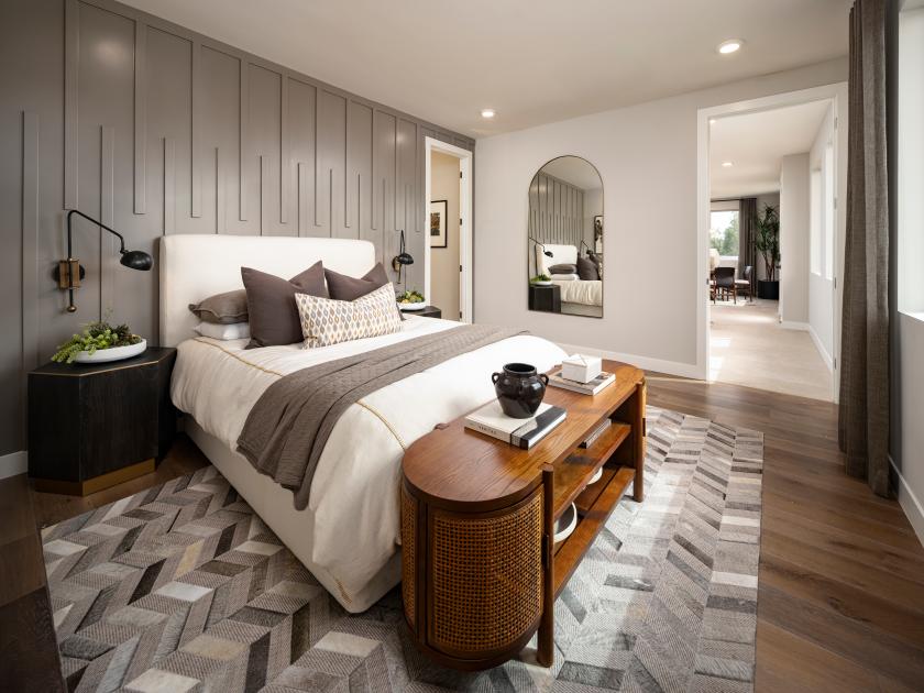 Primary bathroom suite with patterned tile and dual-sink vanity