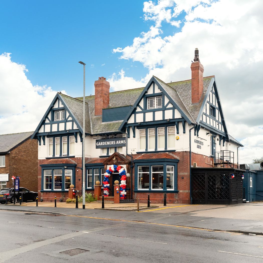 Traditional pub exterior with distinctive architecture and clear signage, offering a welcoming entrance.