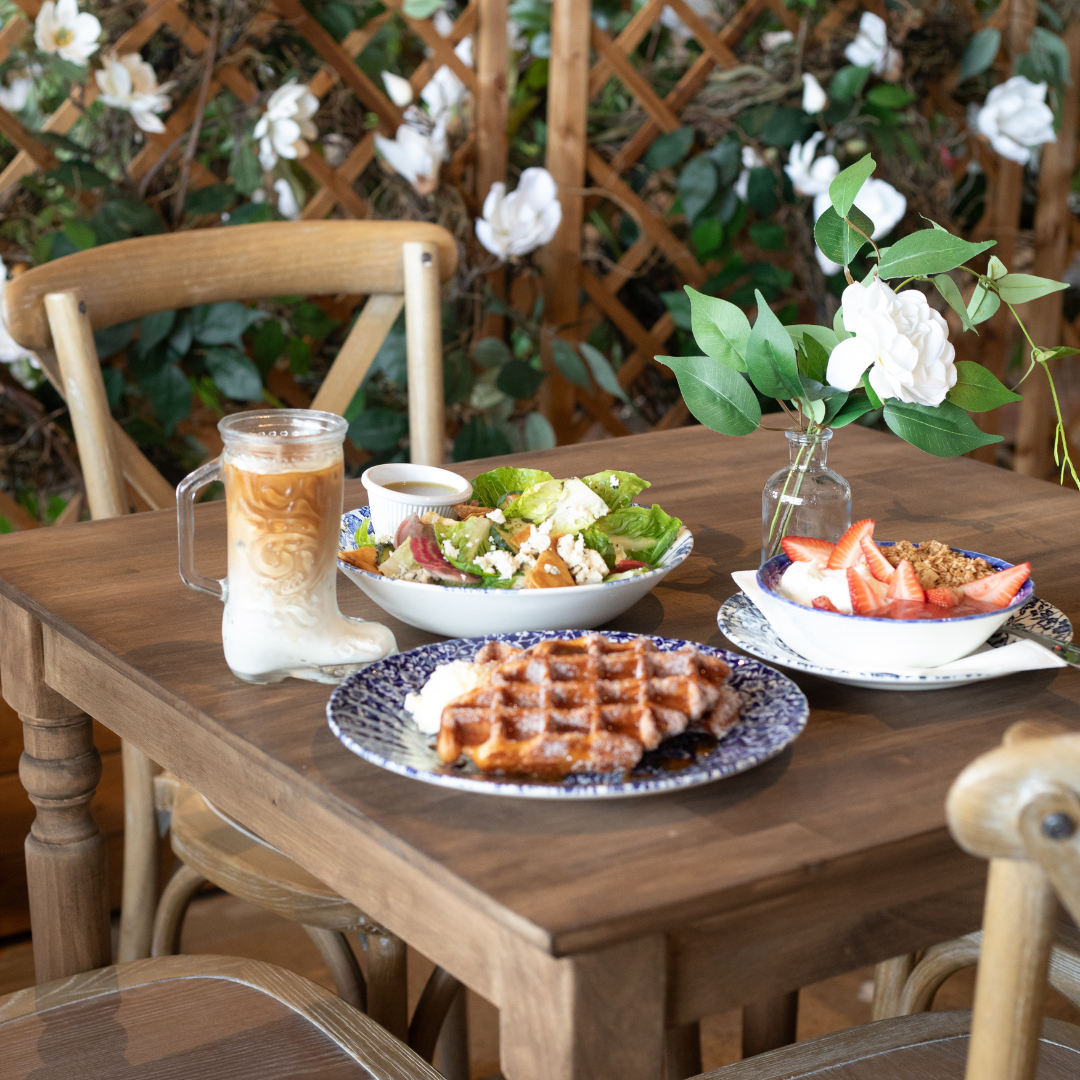 A cozy dining table adorned with a variety of beautifully arranged food and drinks. 