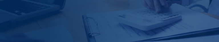 Close-up of a person punching numbers into a calculator.