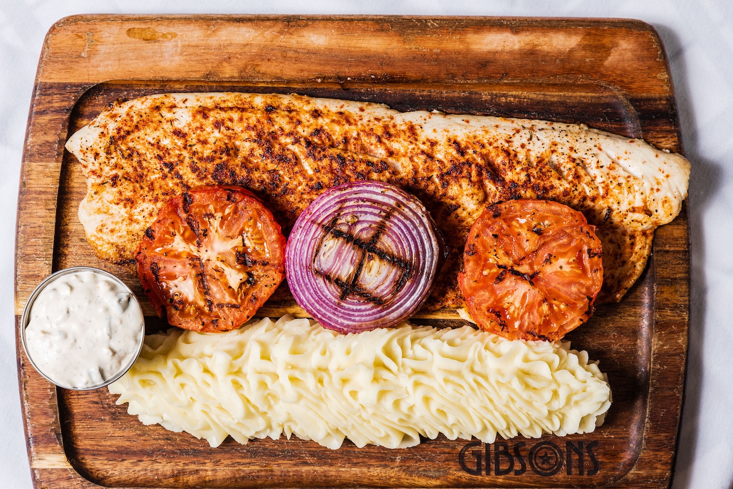 Planked Lake Superior Whitefish is a featured seafood delicacy at Gibsons Bar & Steakhouse in Chicag 