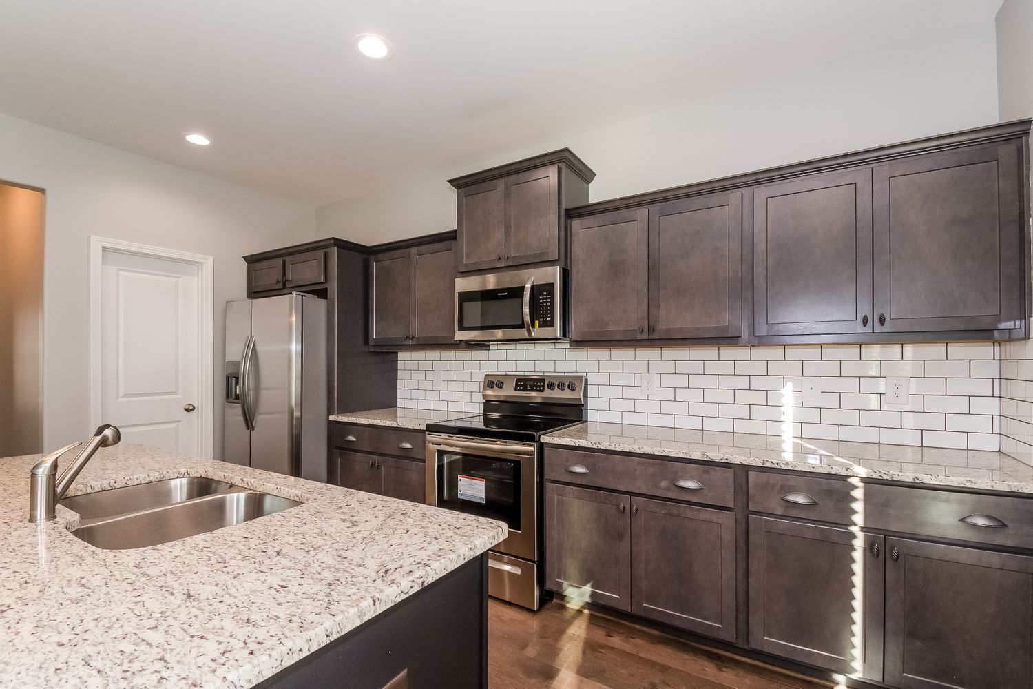 Modern kitchen with stainless steel appliances and recessed lighting at Invitation Homes Atlanta.