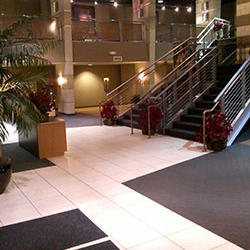 This modern building entryway was professionally cleaned by Dallas Janitorial Services, featuring spotless floors and sanitized surfaces. The pristine entrance creates a positive first impression for visitors and employees alike.