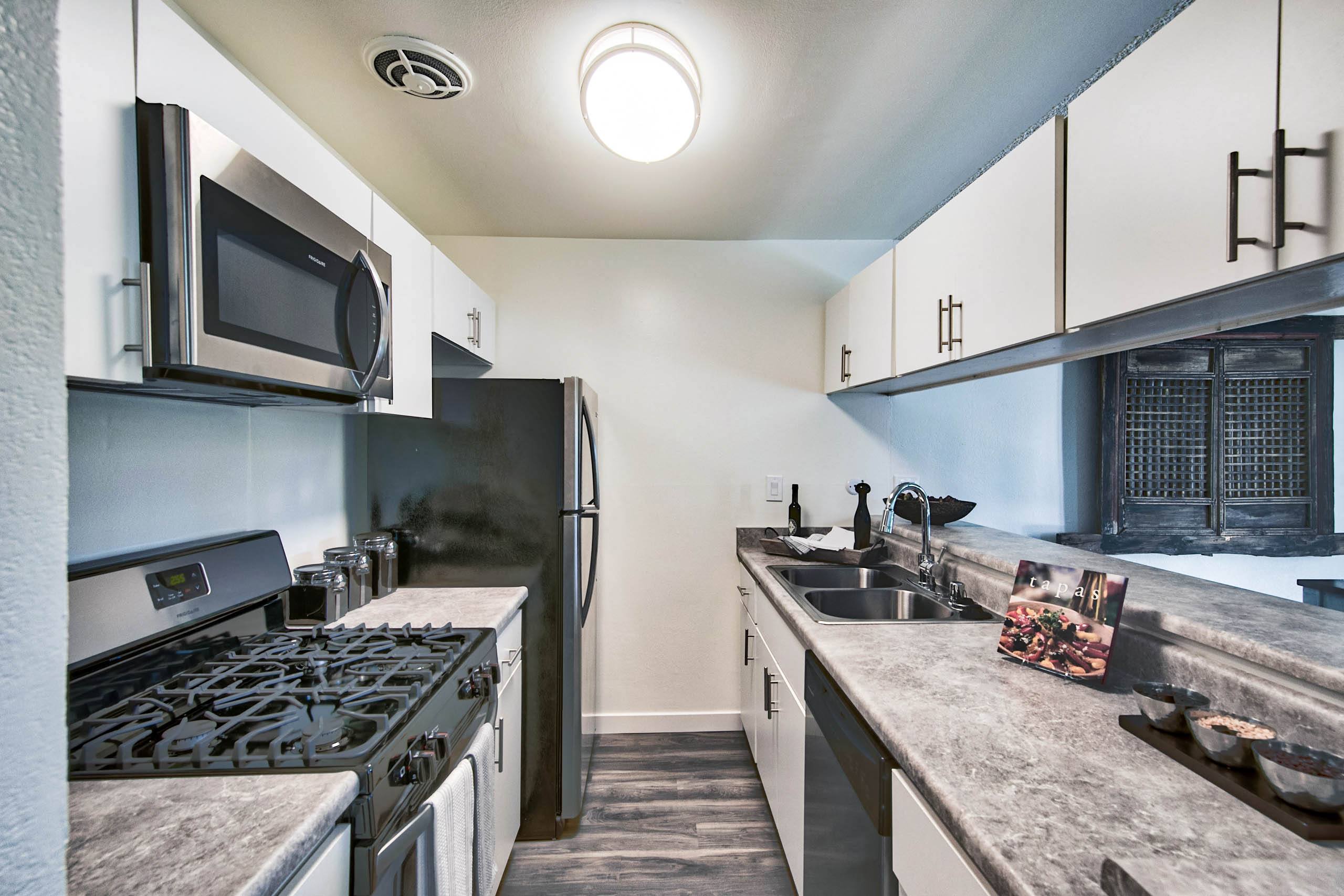 a kitchen with a stove and a sink and a refrigerator