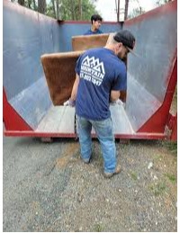 loading trash into a dumpster Mountain Man Junk Removal 
