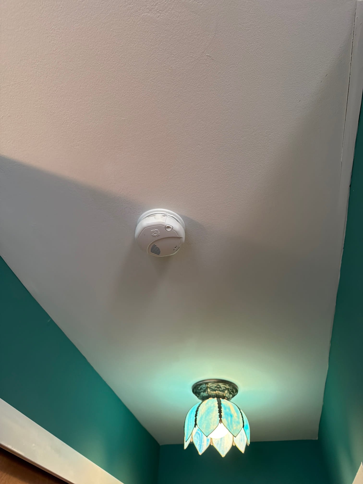 Thomas Edison Electric installed a hardwired smoke detector alongside a stained glass flush-mount ceiling light in a Philadelphia, PA home near Cottman Ave. The combination showcases both safety upgrades and decorative fixture work completed in a single visit.